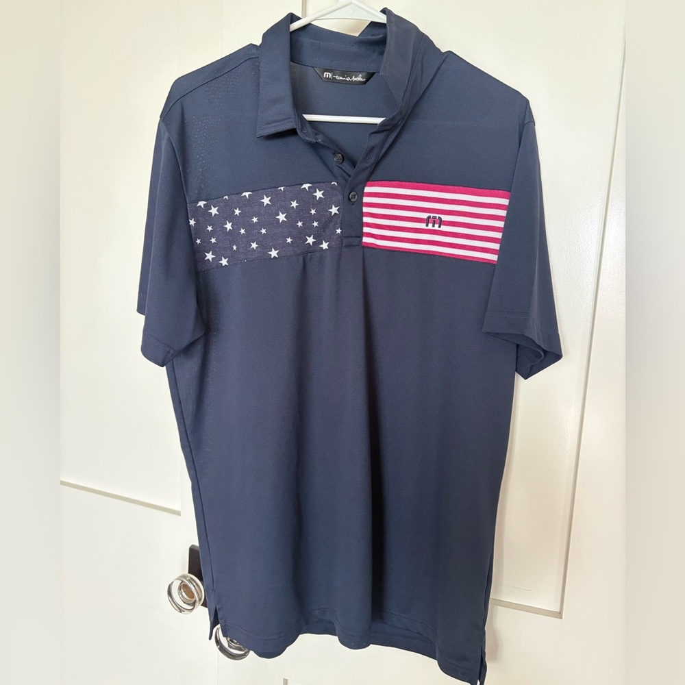 Travis Mathew Navy Polo with Stars and Red-White Stripe Panel
